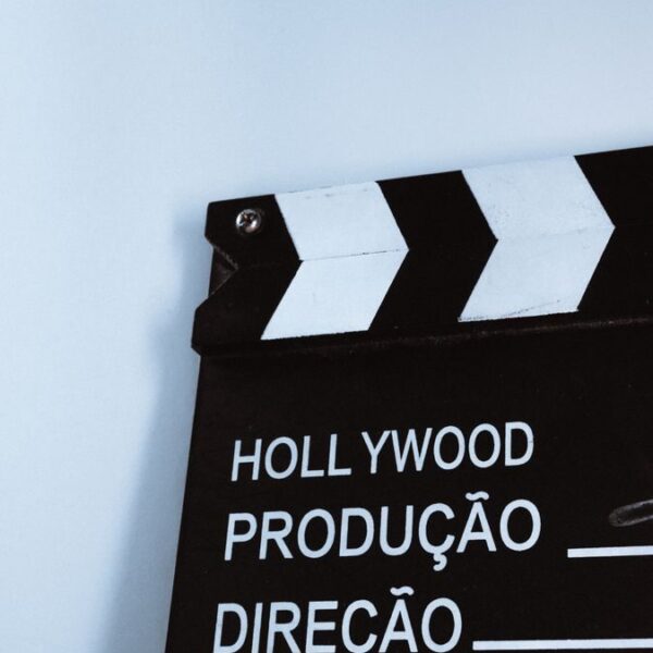 Close-up vertical shot of a clapperboard with text, ideal for film and media themes.