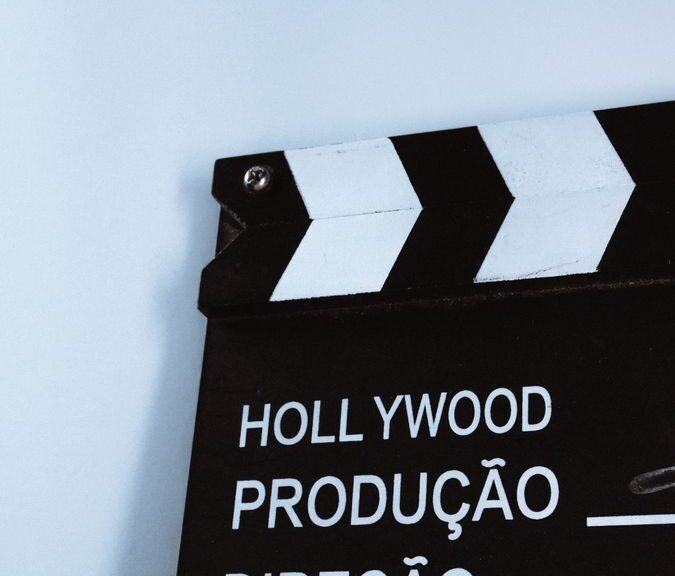 Close-up vertical shot of a clapperboard with text, ideal for film and media themes.