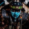 Vibrant tribal costume featuring face paint, feathers, and intricate details.