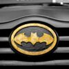 A detailed image of the iconic Batman logo on a car's grill, highlighting superhero symbolism.