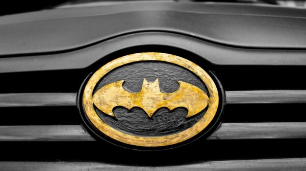 A detailed image of the iconic Batman logo on a car's grill, highlighting superhero symbolism.