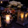 Lanterns with candles illuminate a cemetery on All Saints' Day.