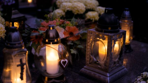 Lanterns with candles illuminate a cemetery on All Saints' Day.