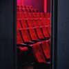 A view of empty red theater seats in a dimly lit cinema in Tehran, Iran.