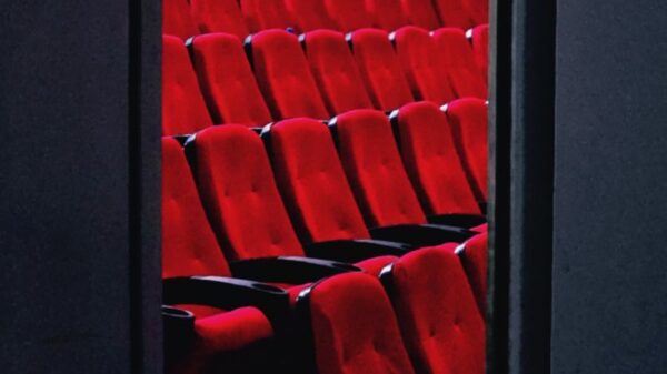 A view of empty red theater seats in a dimly lit cinema in Tehran, Iran.