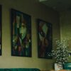 Charming Meknes cafe interior with abstract paintings, artistic vibe, vintage seating, and floral decor.