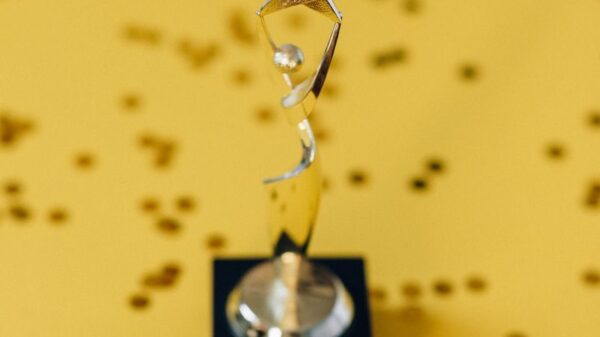 Silver star trophy on yellow background with confetti. Perfect for success concepts.