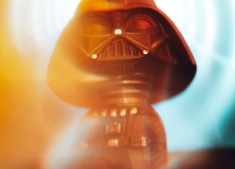 Miniature Darth Vader figurine with vibrant light effects adds a touch of fantasy.