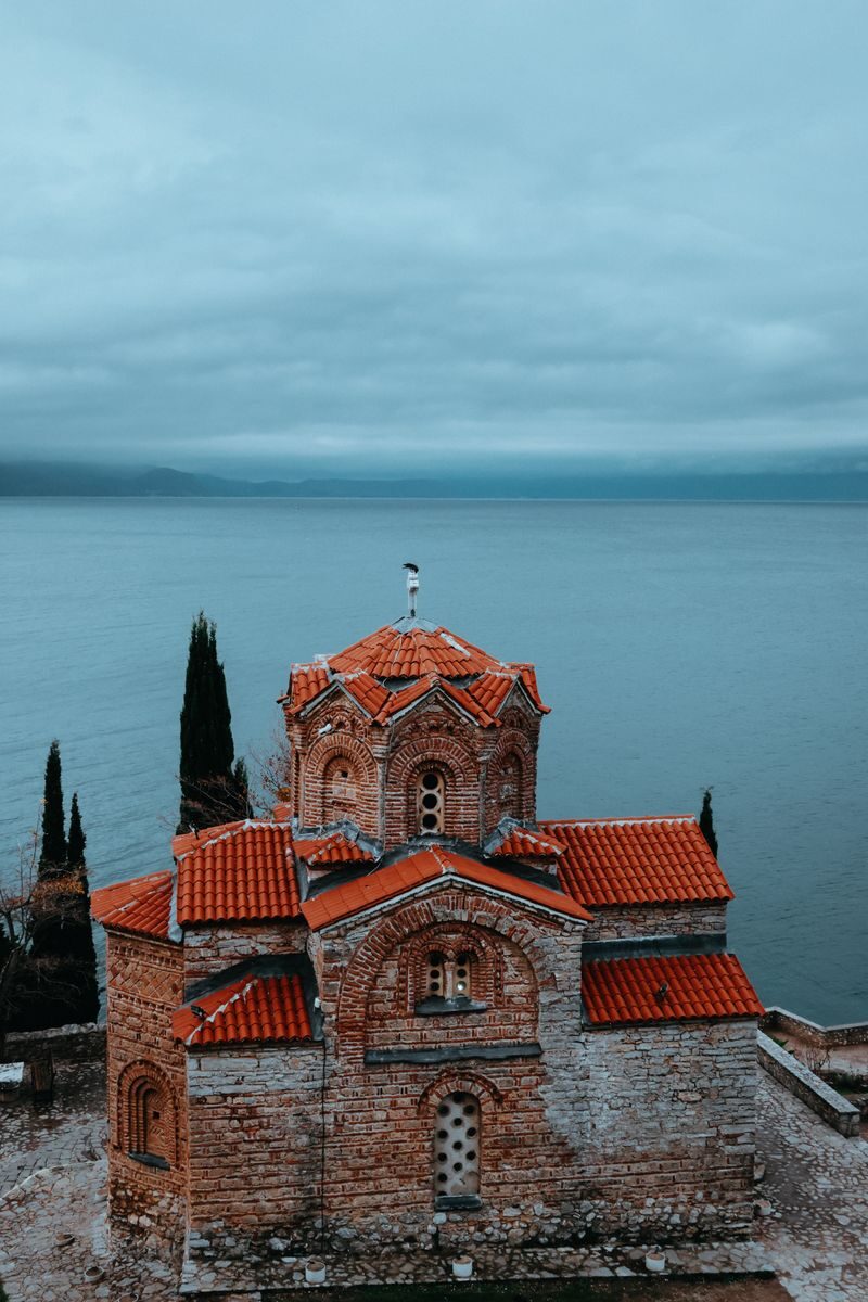 Serene view of St. John at Kaneo with Lake Ohrid in the background, North Macedonia.