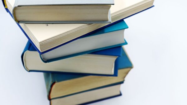 A pile of books with blue covers on a white background, symbolizing education and knowledge.
