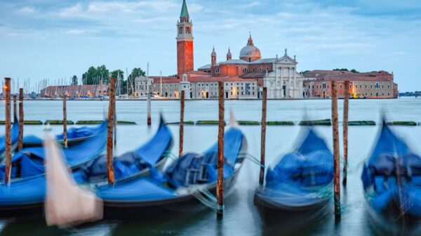 Charming view of San Giorgio Maggiore and gondolas in Venice, Italy, with a beautiful water canal scene.