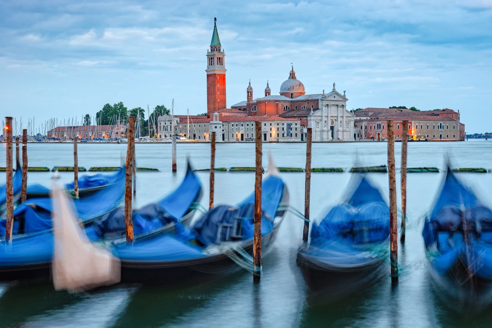 Charming view of San Giorgio Maggiore and gondolas in Venice, Italy, with a beautiful water canal scene.