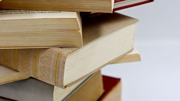 A vertical stack of various hardcover books with visible pages, ideal for literature themes.