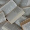 pile of open paperback books