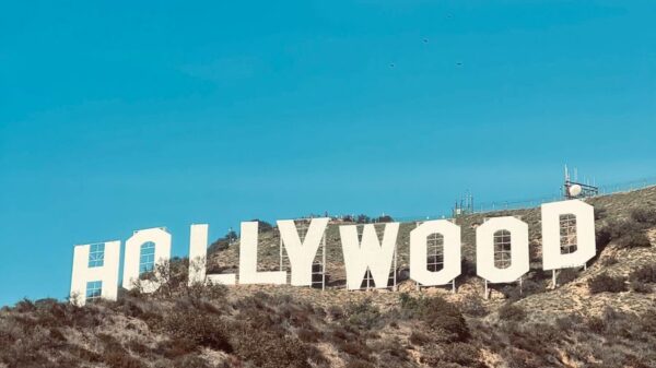 Famous Hollywood Sign under clear blue skies in Los Angeles, CA.