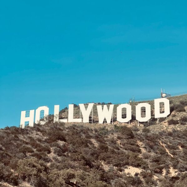 Famous Hollywood Sign under clear blue skies in Los Angeles, CA.