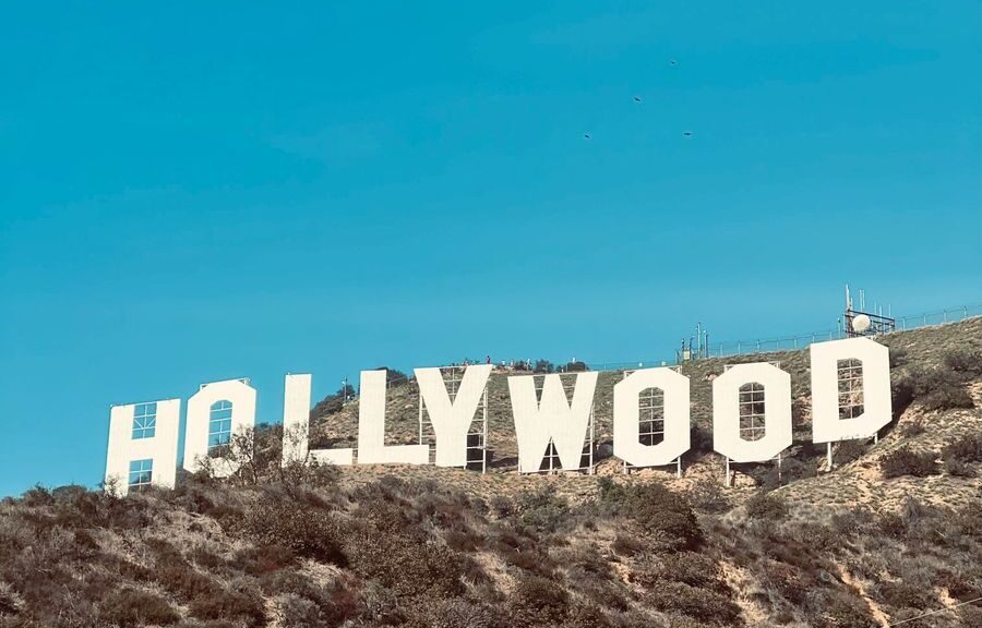 Famous Hollywood Sign under clear blue skies in Los Angeles, CA.