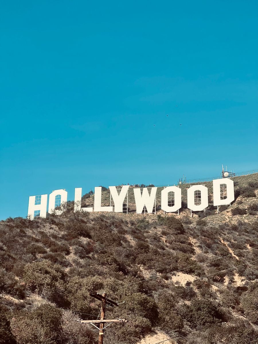 Famous Hollywood Sign under clear blue skies in Los Angeles, CA.