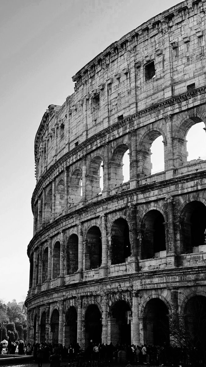 Classic black and white image of the Colosseum highlighting its architectural grandeur.
