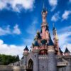 Magical view of the iconic Disneyland Paris castle with a vibrant blue sky.