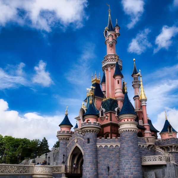 Magical view of the iconic Disneyland Paris castle with a vibrant blue sky.