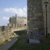 Stone fortress walls at Smederevo with sky in the background. Featuring graffiti and an ancient architectural style.