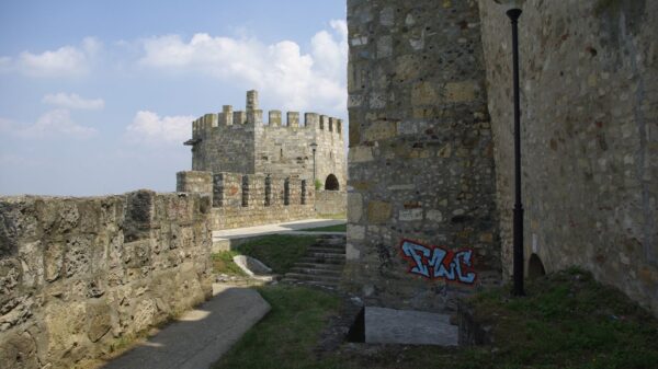 Stone fortress walls at Smederevo with sky in the background. Featuring graffiti and an ancient architectural style.