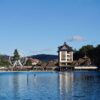 Serene lake view in Zlatibor, Serbia, featuring a Ferris wheel and vibrant landscape, perfect for travel imagery.