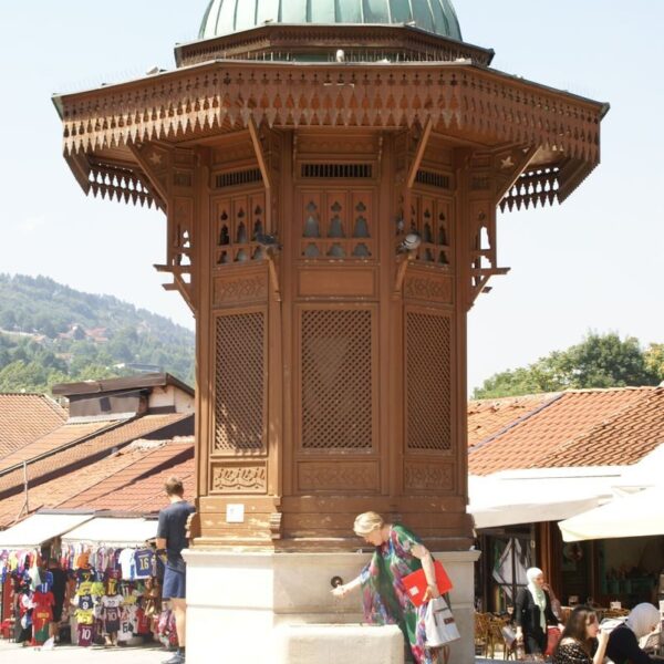 A vibrant scene at the Gazi Husrev-beg's Sebilj Fountain in Sarajevo, capturing cultural essence and tourism.