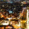 Captivating aerial view of Prizren at night showcasing illuminated streets and architecture.