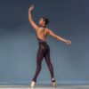 Ballet dancer gracefully posing on stage in a stunning performance.