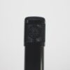 Close-up of a black microphone against a white backdrop, perfect for audio recording themes.