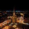 A stunning aerial night view of the illuminated Novi Sad Cathedral in Serbia.