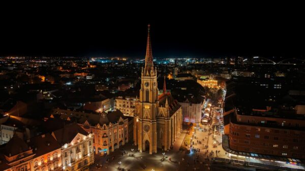 A stunning aerial night view of the illuminated Novi Sad Cathedral in Serbia.