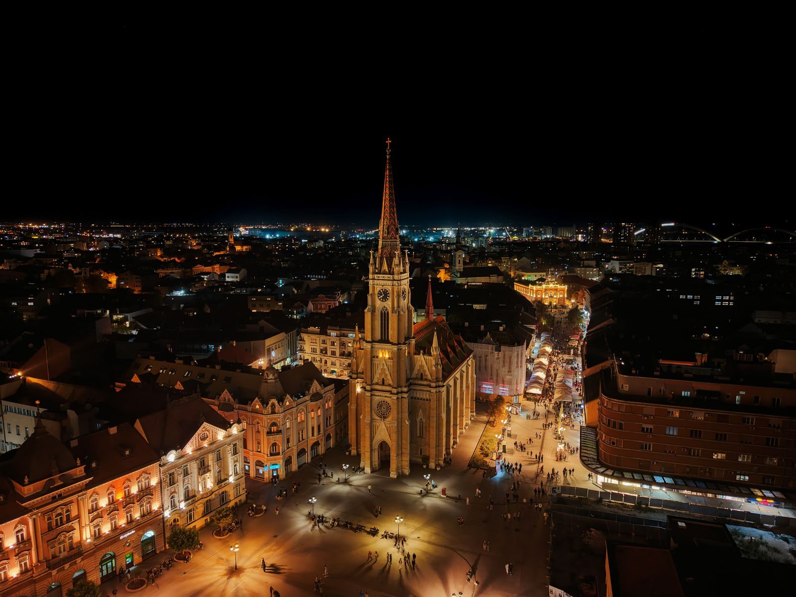 A stunning aerial night view of the illuminated Novi Sad Cathedral in Serbia.