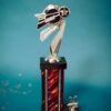 Silver and red dance trophy on blue background with stars and '20'.