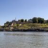 Scenic view of Belgrade Fortress and Sava River under a clear summer sky.