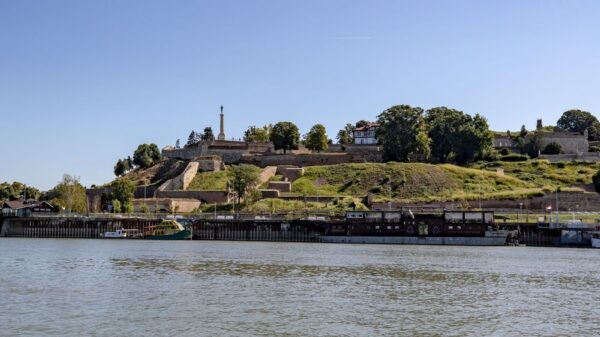 Scenic view of Belgrade Fortress and Sava River under a clear summer sky.
