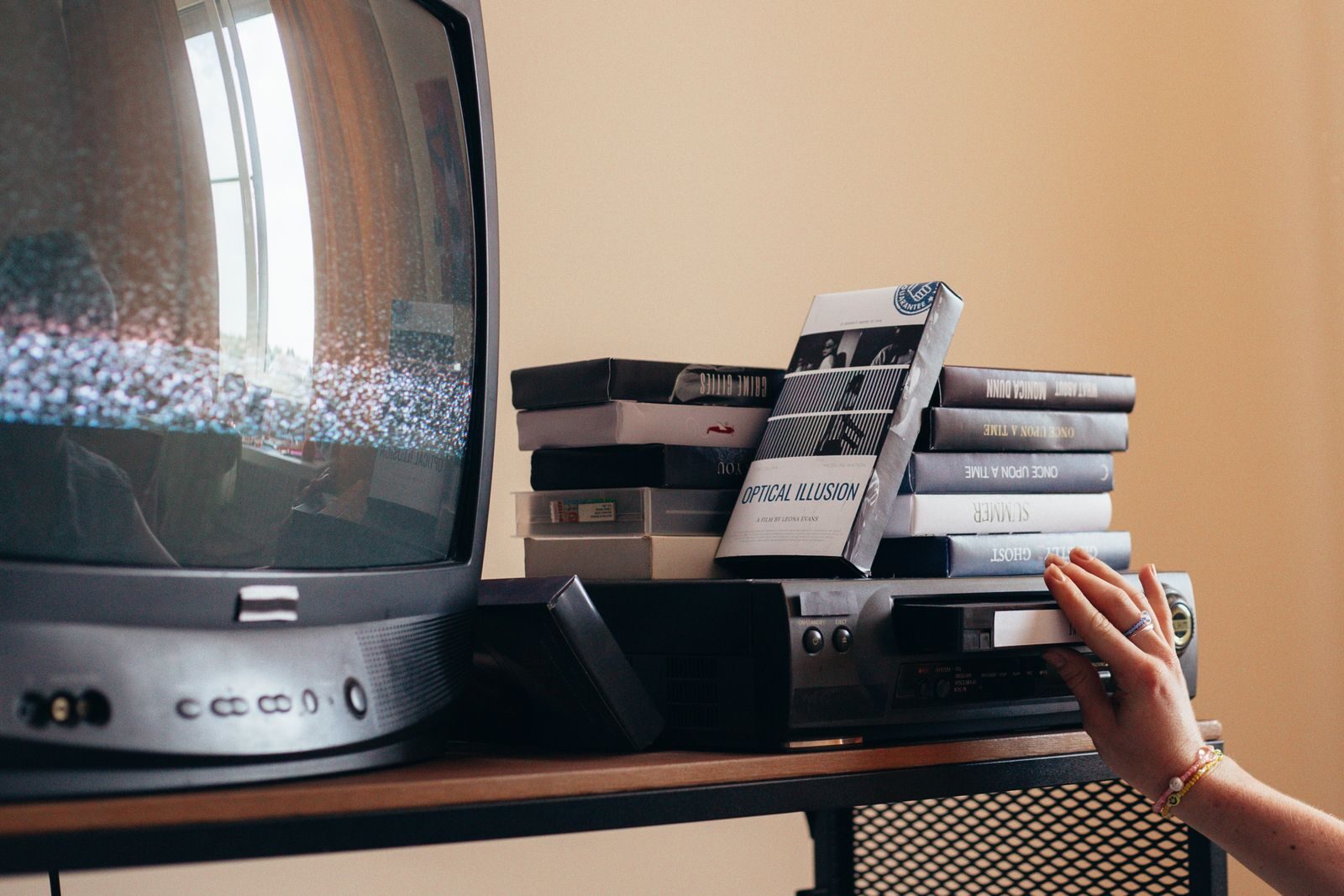 Vintage scene with a VHS player, tapes, and an old CRT TV creating a nostalgic vibe.